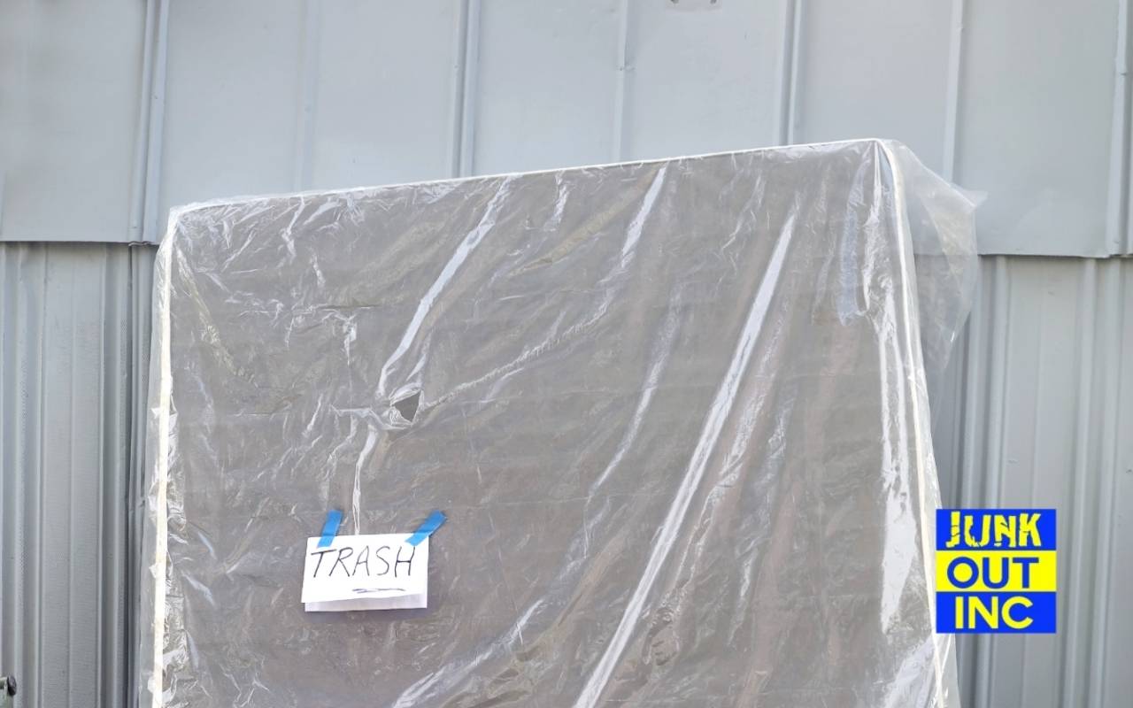 Old mattress wrapped in plastic, waiting for bulk pickup in New York